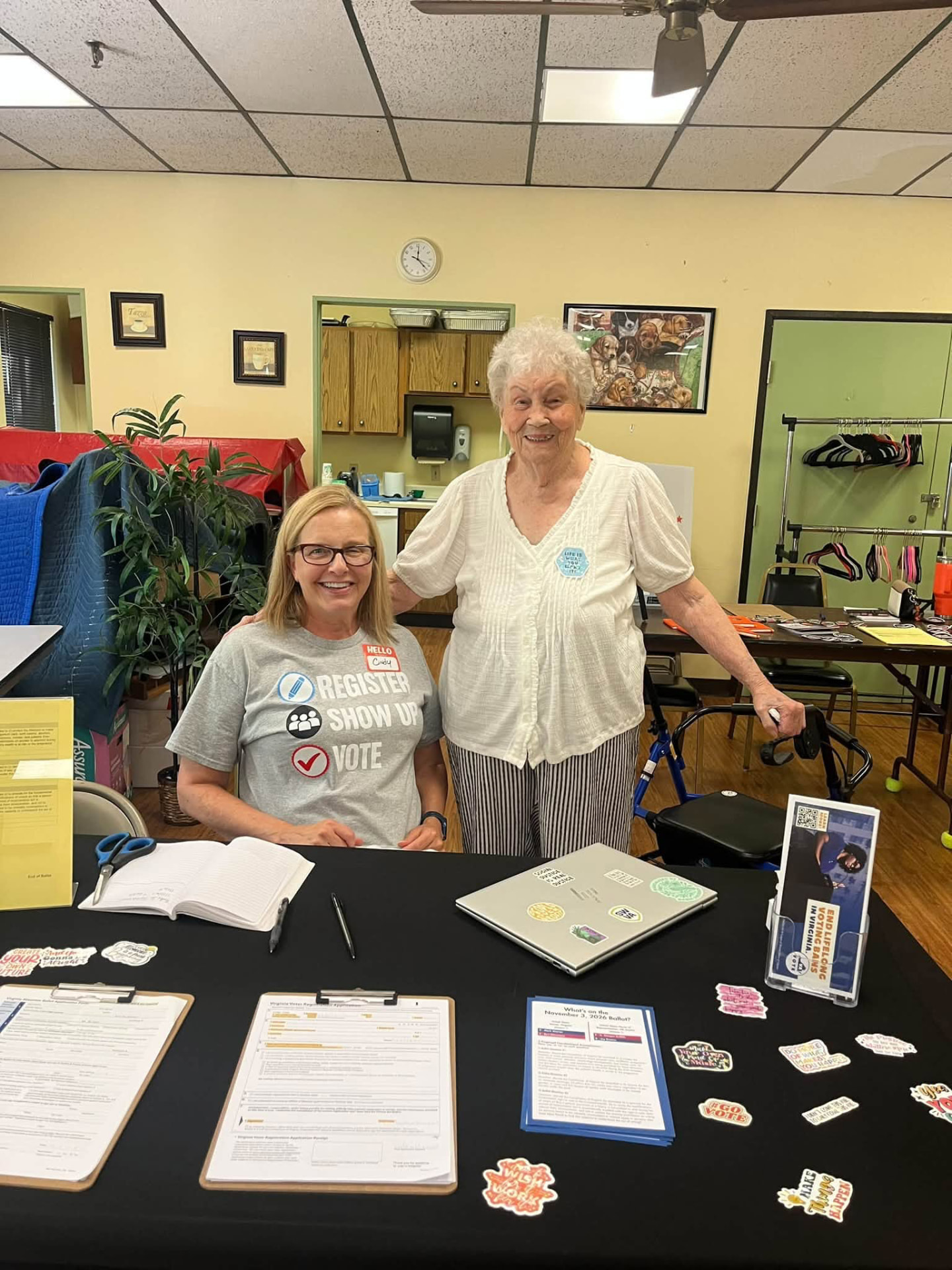 Cindy at a voter registration table with a neighbor