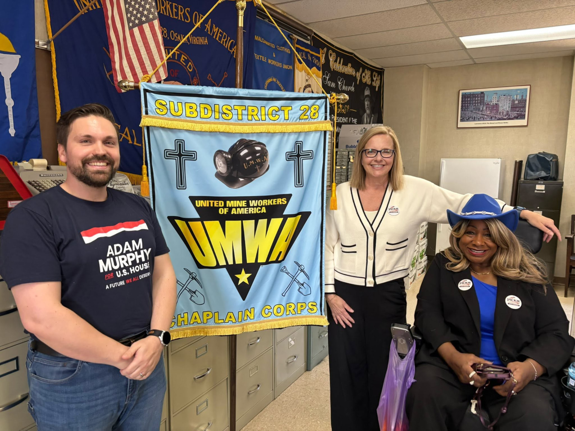 Cindy with friends beside a United Mine Workers of America banner
